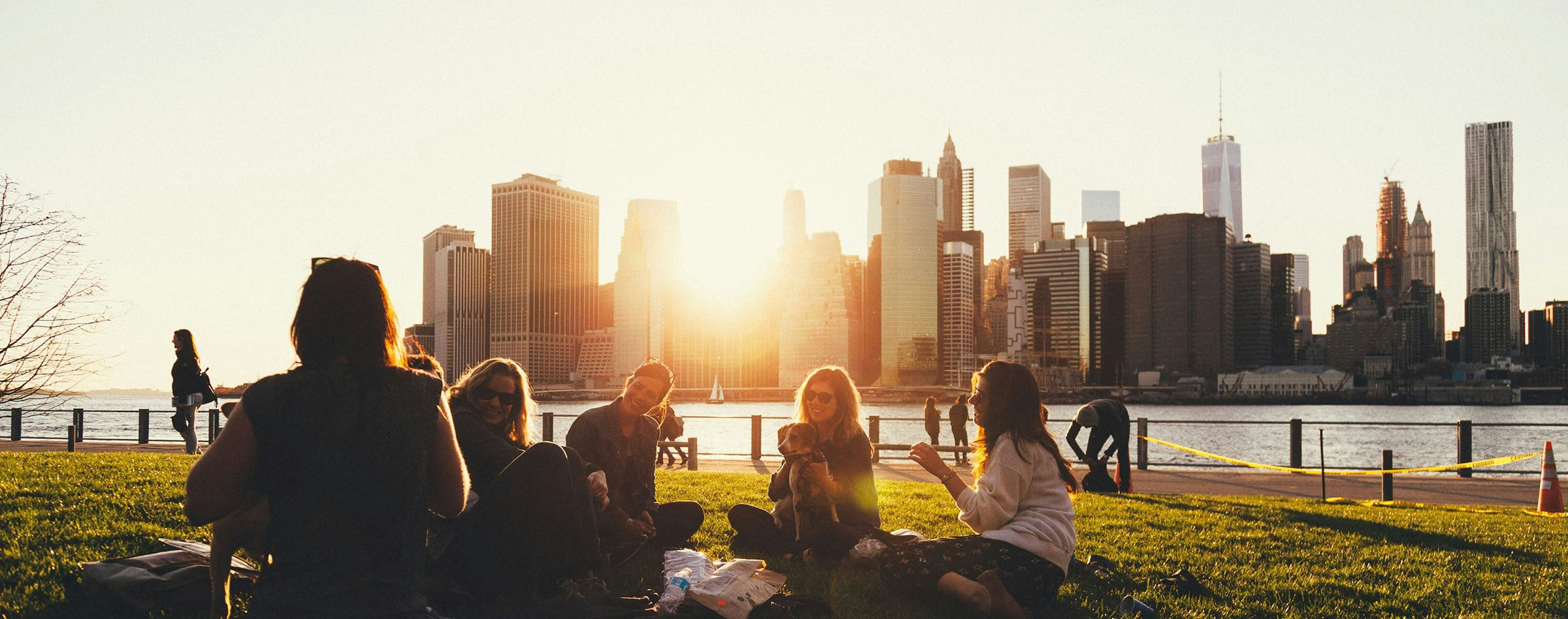 Students relaxing in park at dusk